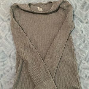 Two gray and black long sleeve boy’s shirts.